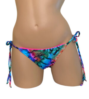 Low waist tie side reversible bikini bottoms in tie dye and pink front view