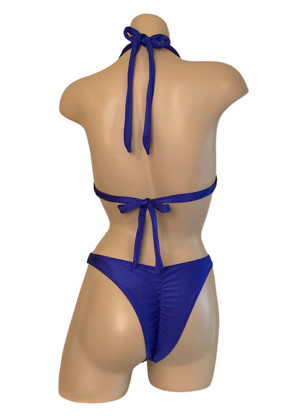 High cut ruched back cheeky bikini bottoms with double strap halter style bikini top in royal blue back view