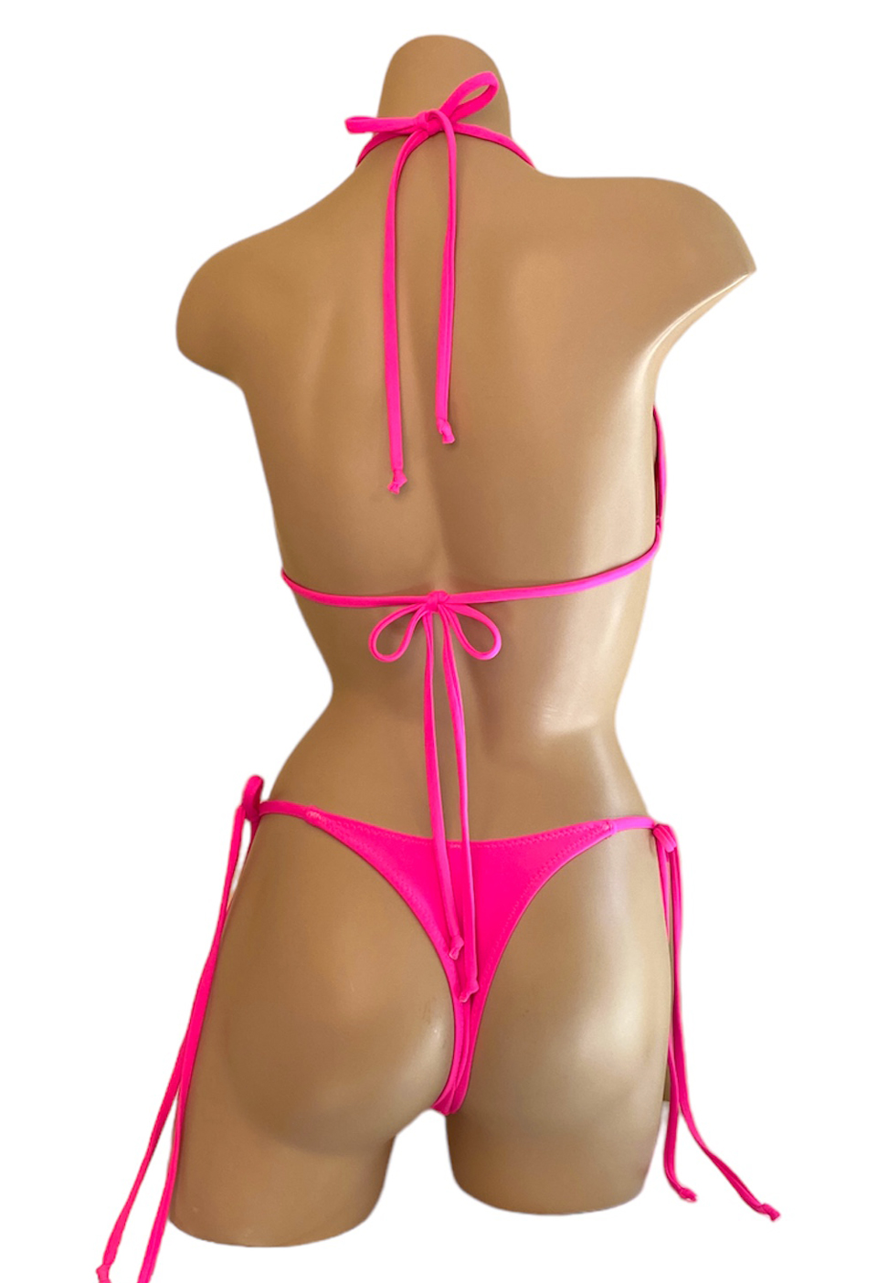 High cut tie side v front very cheeky bikini bottoms and triangle top in hot pink back view