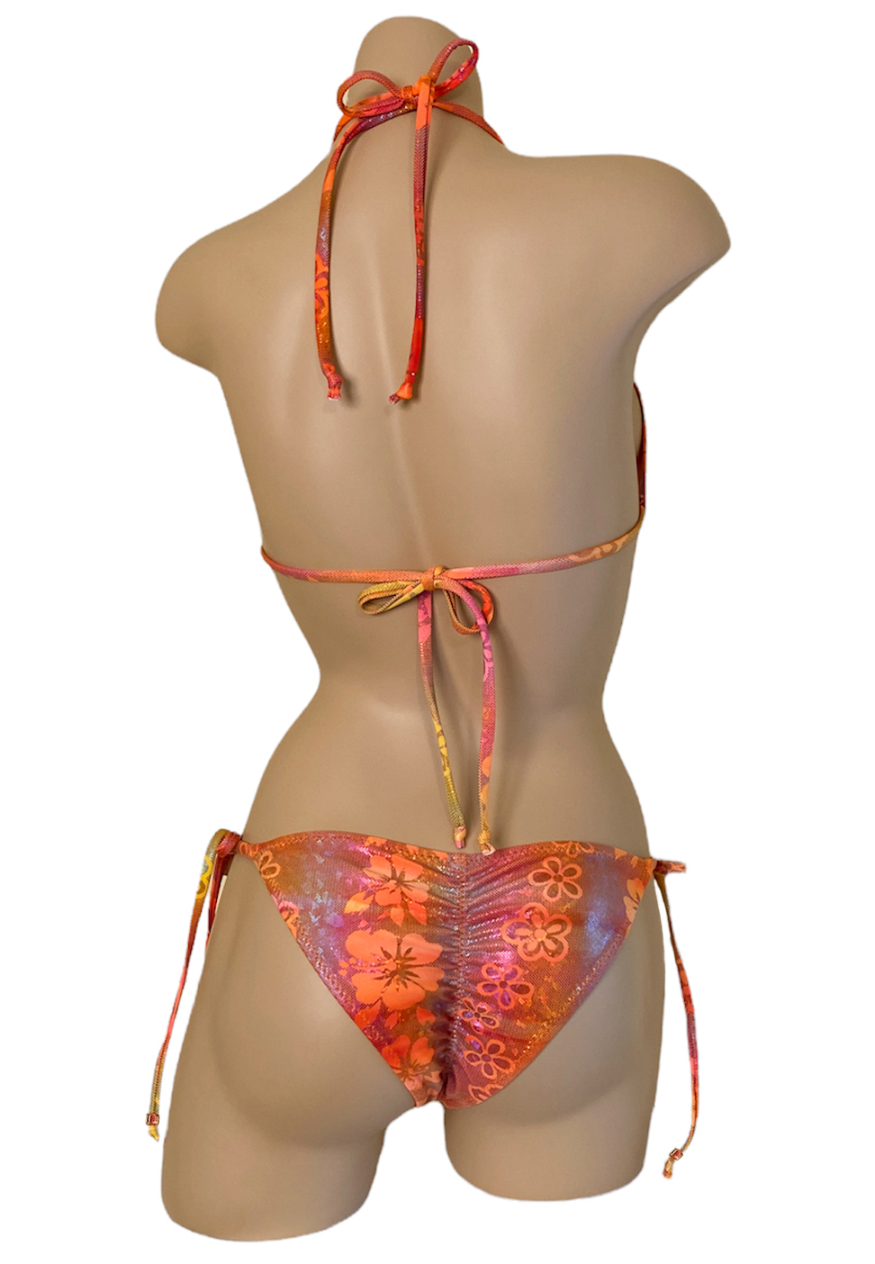 Low waist tie side ruched back bikini bottoms with triangle top in orange holographic floral print and beads back view