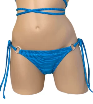 Low waist tie side ruched back bikini bottoms in blue zebra print with crystal side rings front view