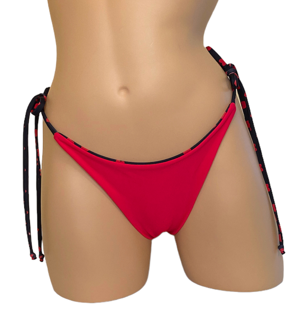 High hip tie side reversible bikini bottoms in red hearts print reverse side front view