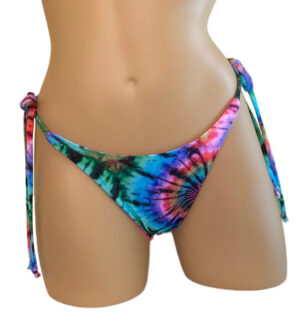 Reversible high cut tie side ruched back bikini bottoms in tie dye with hot pink on the reverse