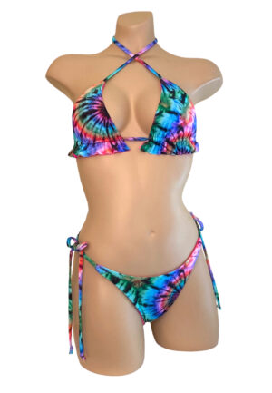 High cut tie side reversible bikini bottoms and reversible ruffle triangle top in tie dye print front view