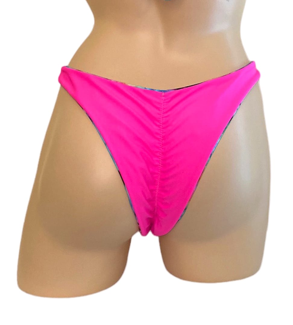 Reversible high cut bikini bottoms in tie dye with hot pink on the reverse pink side back view
