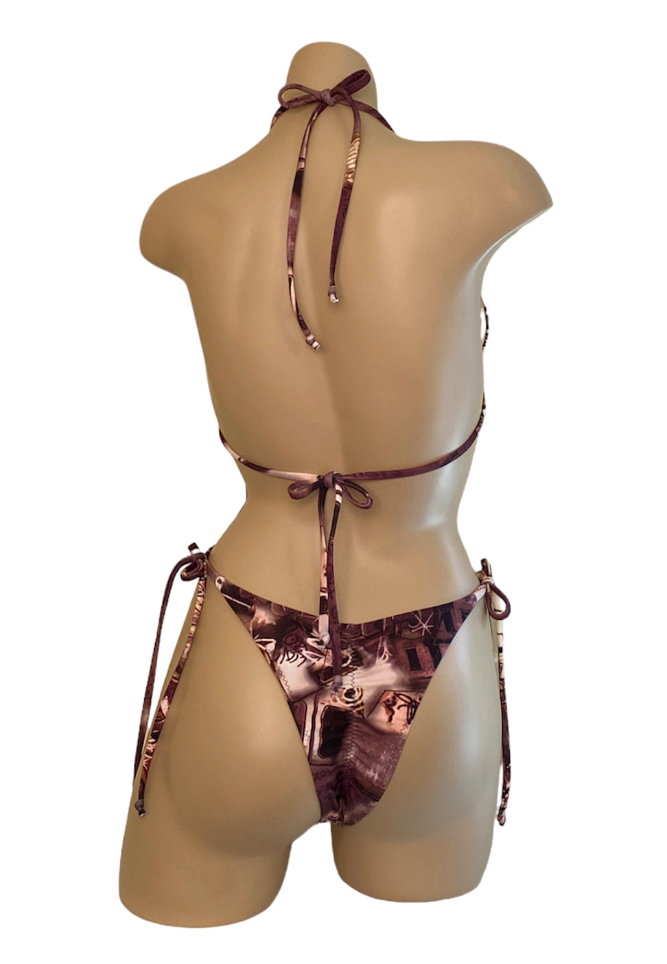 High cut ruched back tie side bikini bottoms with gold side rings and triangle top with gold center ring in brown tones graffiti print back view