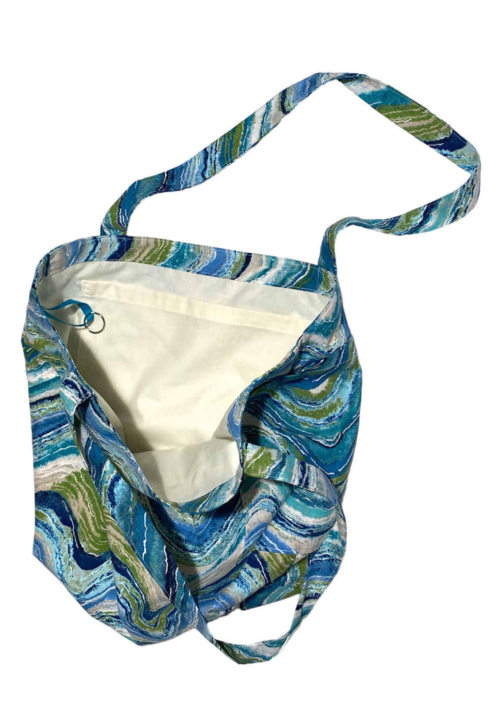 large canvas tote beach bag in colorful wavy print in shades of blue side view