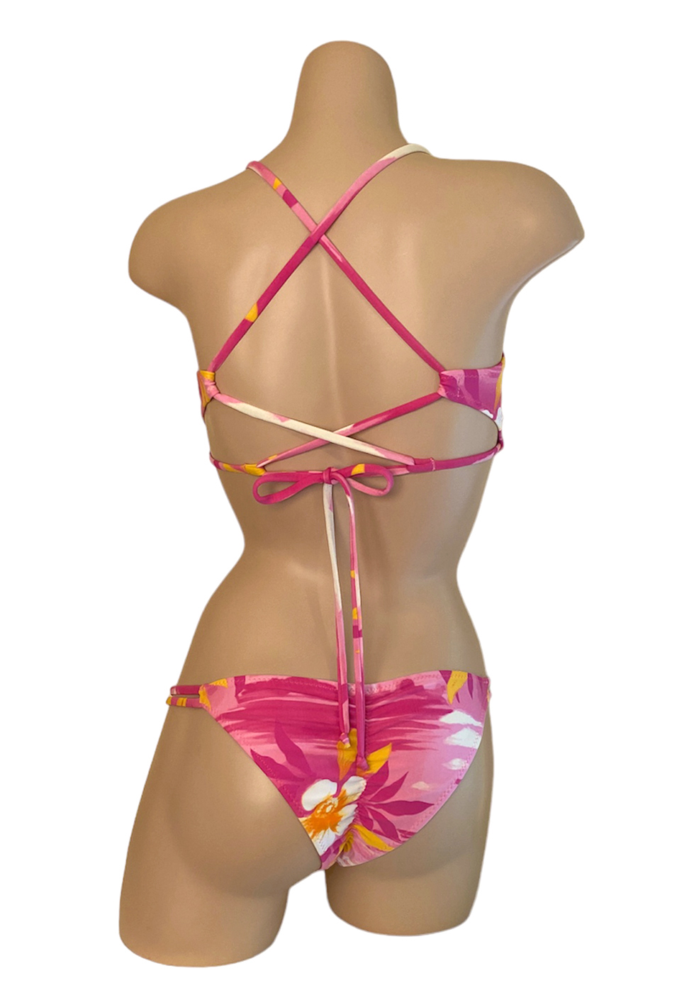 Low waist, double side strap with side beads, ruched back bikini bottoms and peek-a-boo cross back, adjustable bikini top in Tropical pink print back view