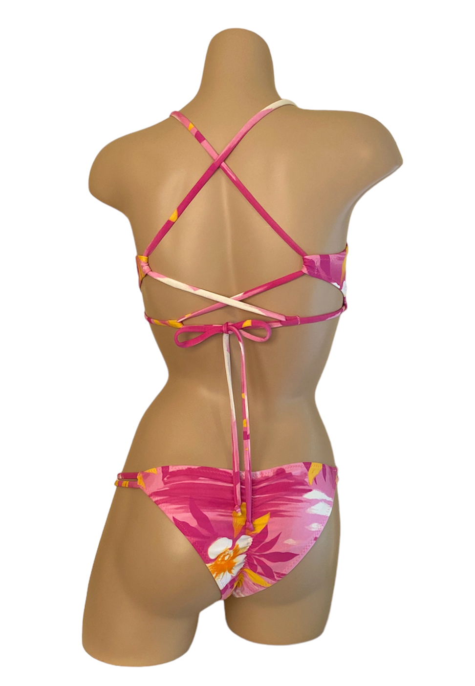 Low waist, double side strap with side beads, ruched back bikini bottoms and peek-a-boo cross back, adjustable bikini top in Tropical Barbie print back view