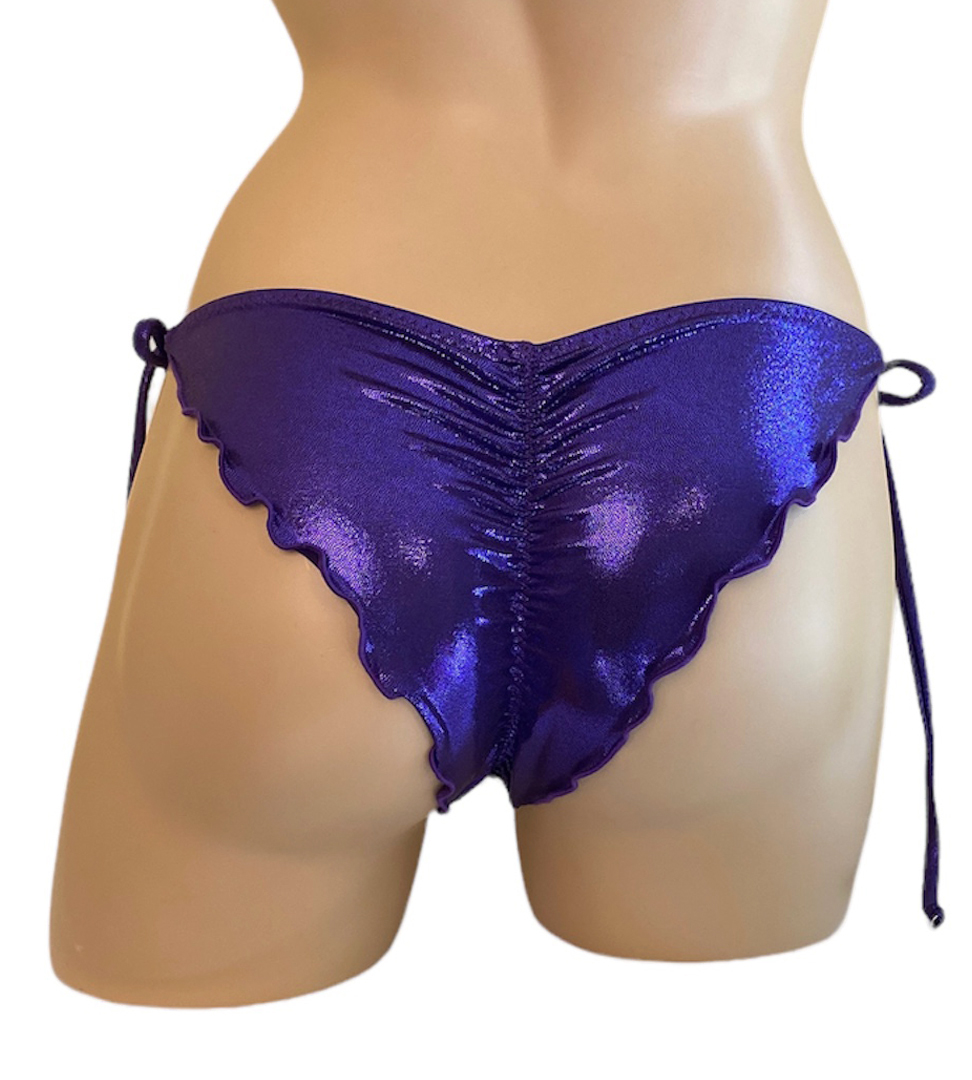 Low waist tie side ruched wavy back bikini bottoms in metallic purple fabric back view