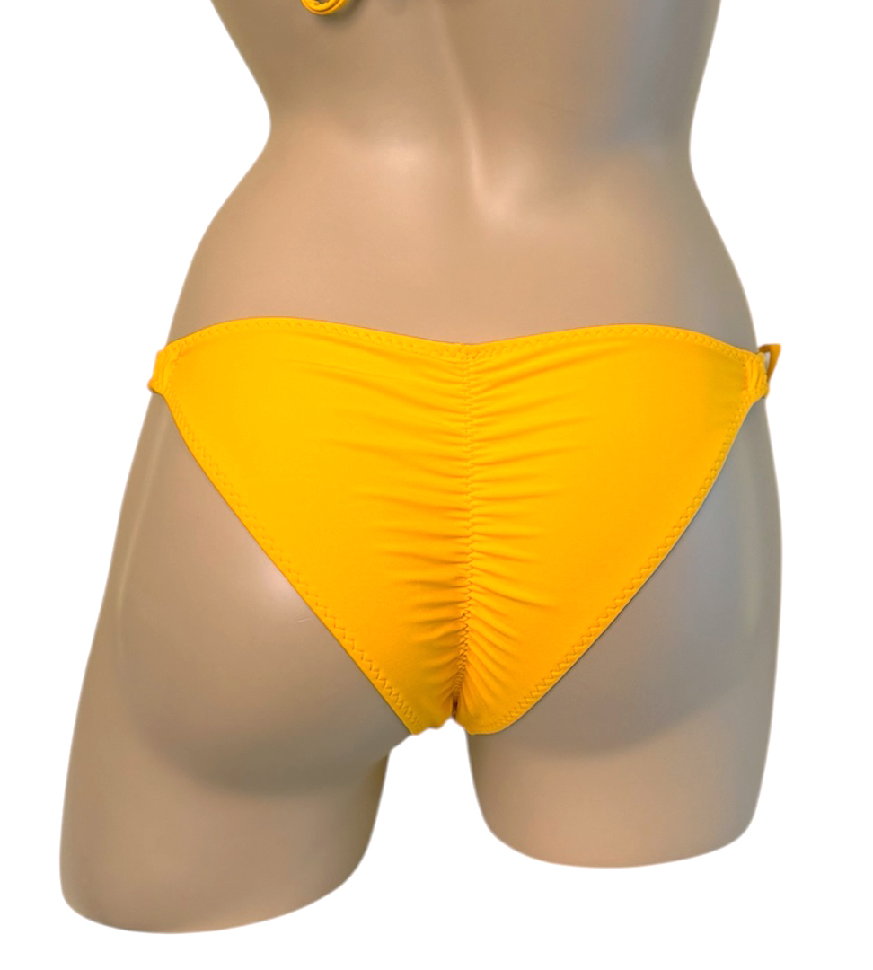 Low waist, ruched, loop tie side bikini bottoms in daffodil yellow with yellow bead details back view