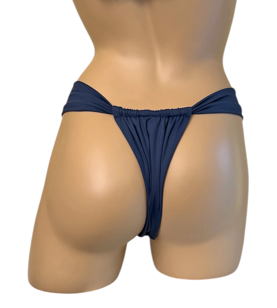 Reversible slide style bikini bottoms in waterlily print with indigo on the reverse indigo side back view