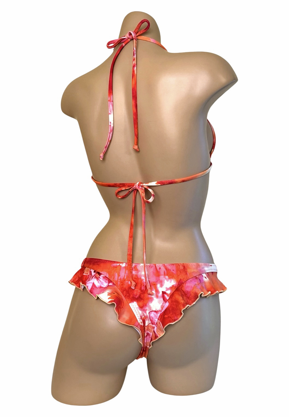 Low waist, cheeky, ruffled bikini bottoms and matching ruffled triangle top in tropical floral sunset print back view